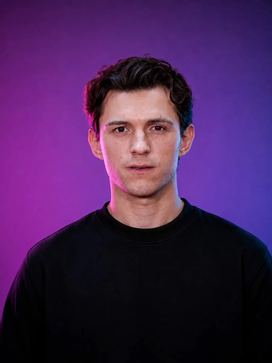 A realistic male editorial studio portrait with black oversized T-shirt, purple-blue gradient background, soft frontal fill, and cinematic magenta/electric-blue highlights.