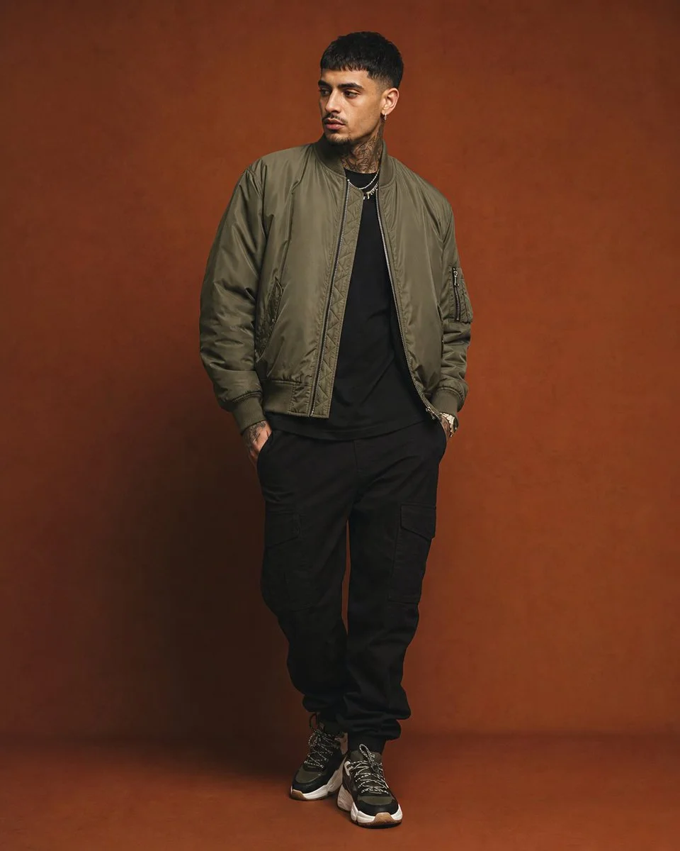 A premium streetwear editorial portrait against a vibrant seamless backdrop with a complementary color palette and minimalist composition.